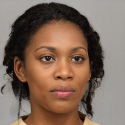 Joyful black young-adult female with medium  brown hair and brown eyes