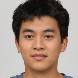 Joyful asian young-adult male with short  black hair and brown eyes