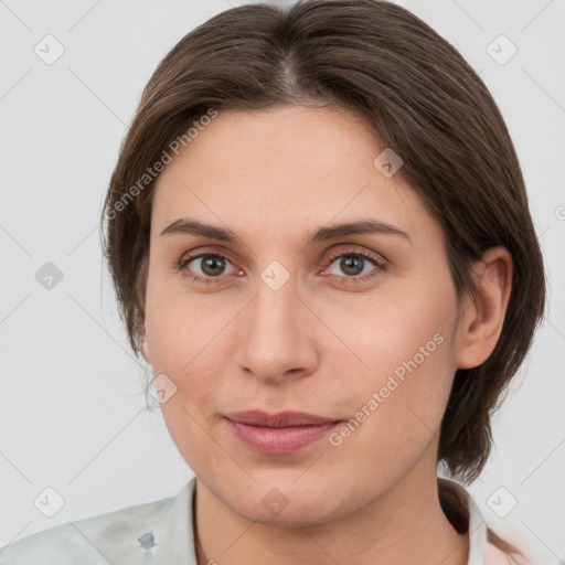 Joyful white young-adult female with medium  brown hair and grey eyes