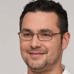 Joyful white adult male with short  brown hair and brown eyes