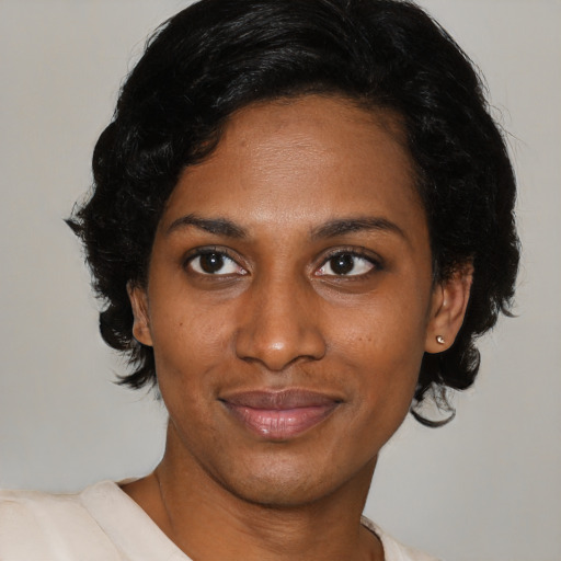 Joyful black young-adult female with medium  brown hair and brown eyes