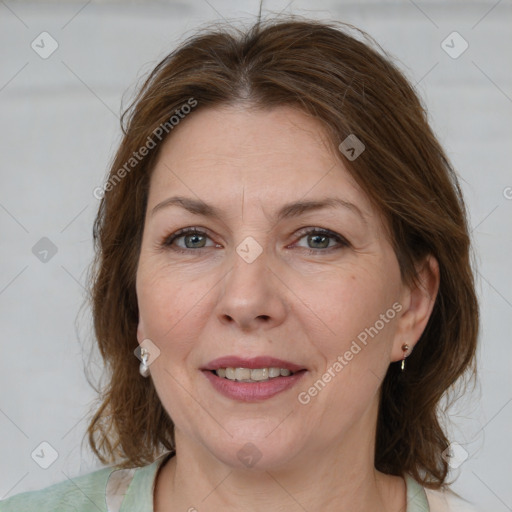 Joyful white adult female with medium  brown hair and grey eyes