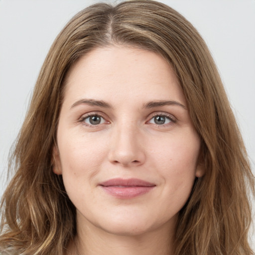 Joyful white young-adult female with long  brown hair and green eyes