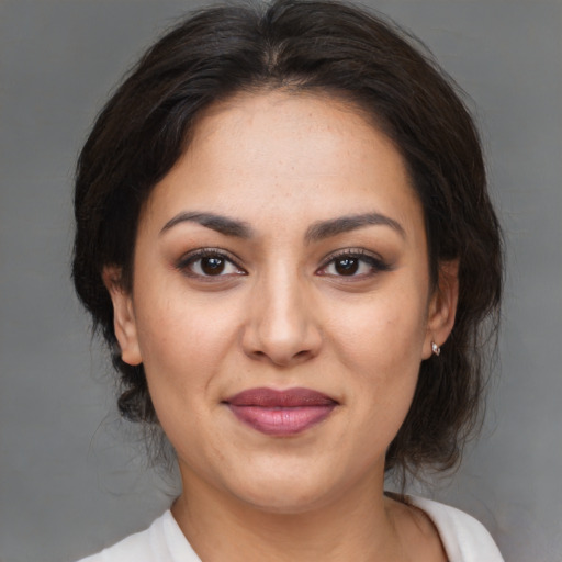 Joyful asian adult female with medium  brown hair and brown eyes