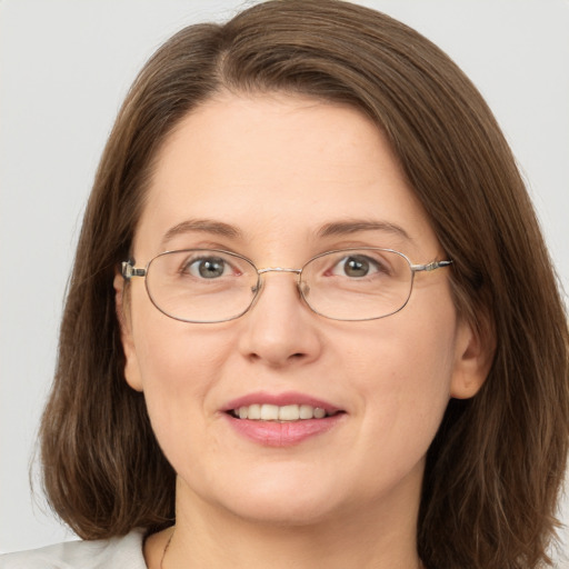 Joyful white adult female with medium  brown hair and grey eyes