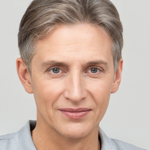 Joyful white adult male with short  brown hair and grey eyes