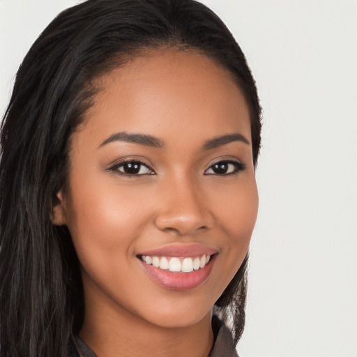 Joyful latino young-adult female with long  brown hair and brown eyes