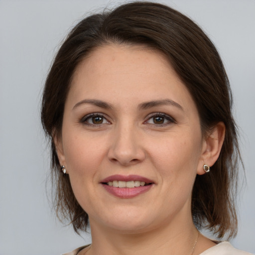 Joyful white young-adult female with medium  brown hair and brown eyes