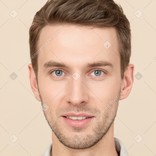 Joyful white young-adult male with short  brown hair and grey eyes