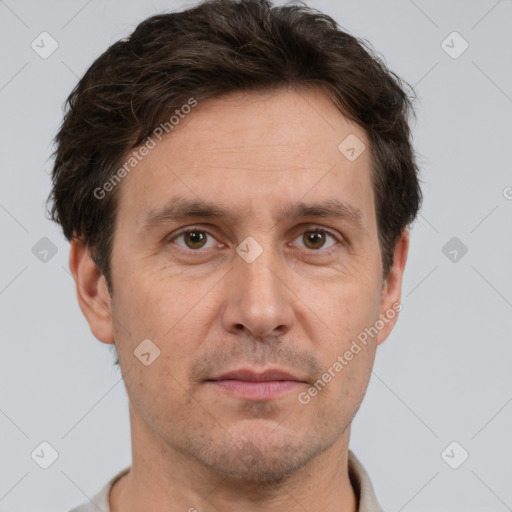 Joyful white adult male with short  brown hair and brown eyes