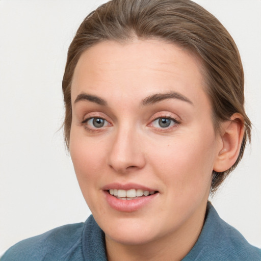 Joyful white young-adult female with medium  brown hair and blue eyes