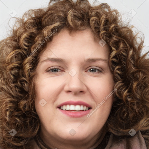 Joyful white young-adult female with long  brown hair and green eyes