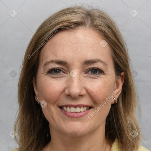 Joyful white adult female with medium  brown hair and grey eyes