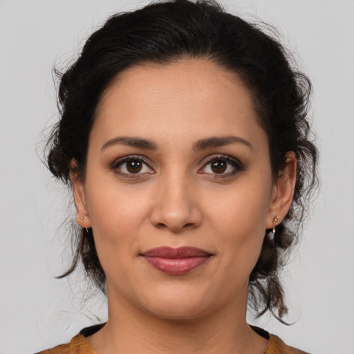 Joyful latino young-adult female with medium  brown hair and brown eyes