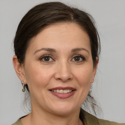 Joyful white adult female with medium  brown hair and grey eyes