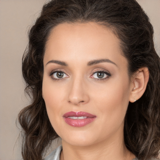 Joyful white young-adult female with long  brown hair and brown eyes