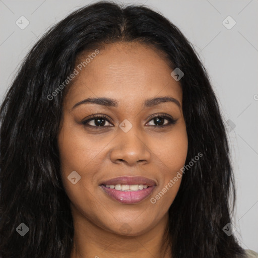 Joyful black young-adult female with long  brown hair and brown eyes