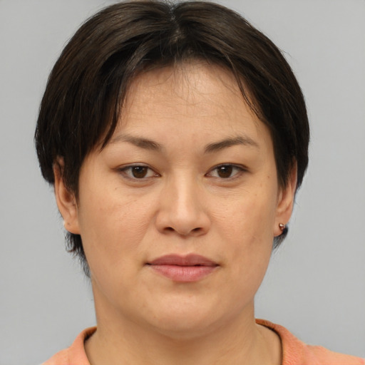 Joyful asian adult female with medium  brown hair and brown eyes