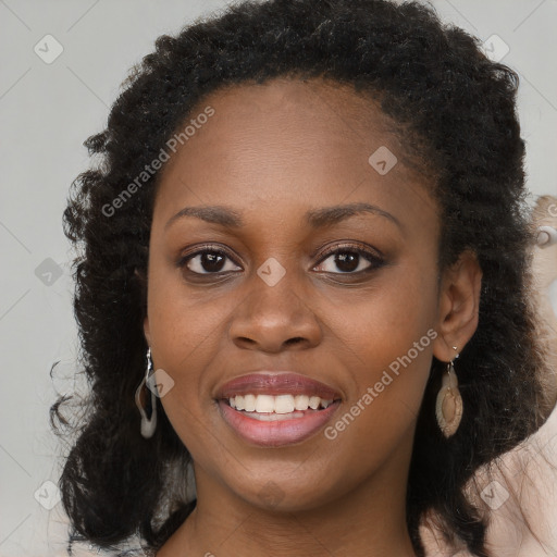 Joyful black young-adult female with long  brown hair and brown eyes