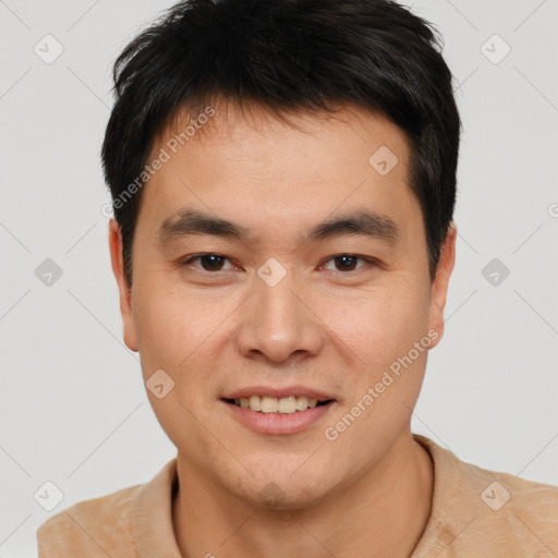 Joyful asian young-adult male with short  brown hair and brown eyes