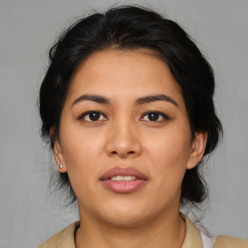 Joyful latino young-adult female with medium  black hair and brown eyes