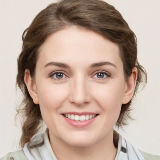 Joyful white young-adult female with medium  brown hair and green eyes