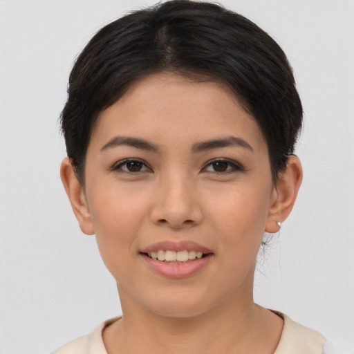 Joyful asian young-adult female with short  brown hair and brown eyes