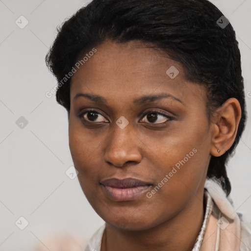 Joyful black young-adult female with short  black hair and brown eyes