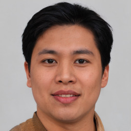 Joyful asian young-adult male with short  brown hair and brown eyes