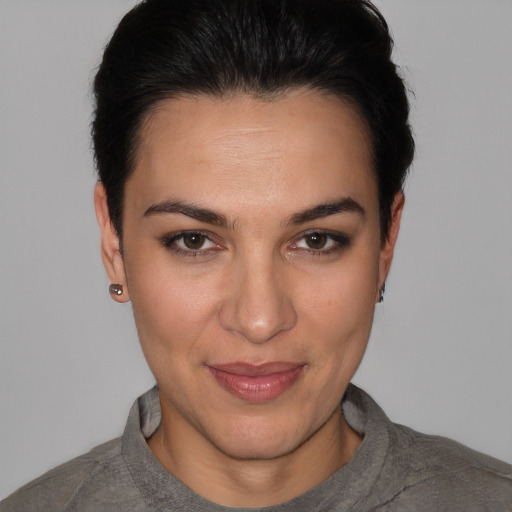 Joyful white young-adult female with short  black hair and brown eyes