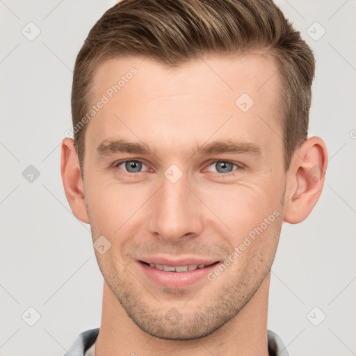 Joyful white young-adult male with short  brown hair and grey eyes