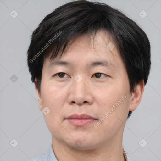 Joyful asian adult male with short  brown hair and brown eyes