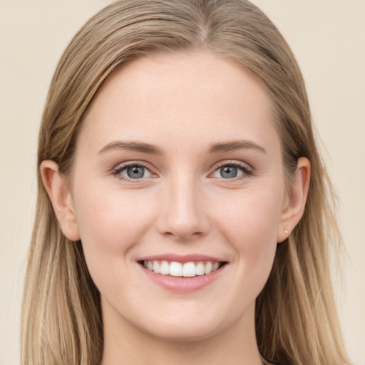 Joyful white young-adult female with long  brown hair and blue eyes