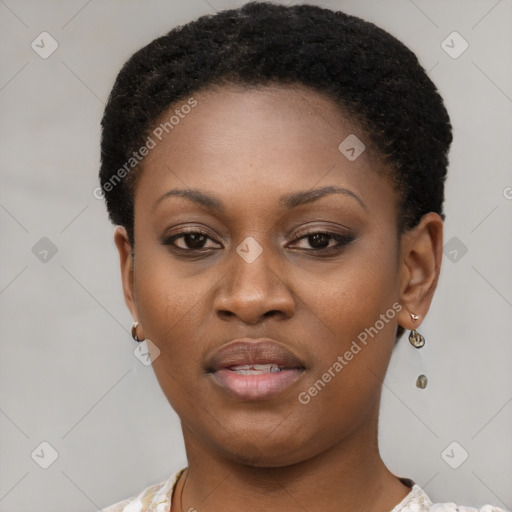 Joyful black young-adult female with short  black hair and brown eyes