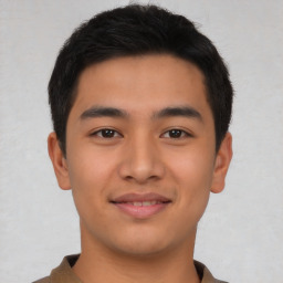 Joyful asian young-adult male with short  brown hair and brown eyes