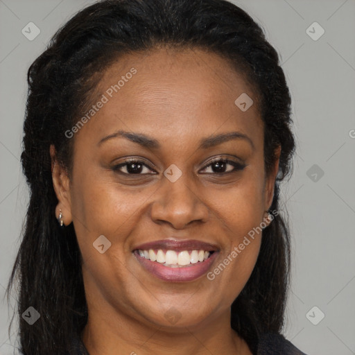 Joyful black adult female with long  brown hair and brown eyes