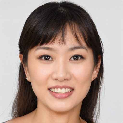 Joyful asian young-adult female with long  brown hair and brown eyes