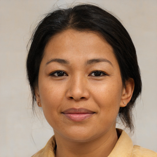 Joyful asian adult female with medium  brown hair and brown eyes