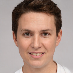 Joyful white adult male with short  brown hair and grey eyes