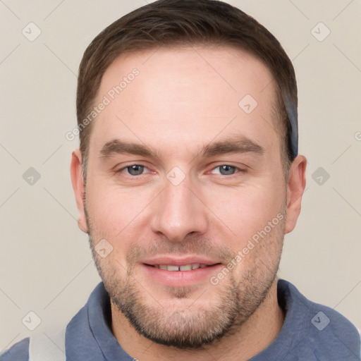 Joyful white young-adult male with short  brown hair and grey eyes