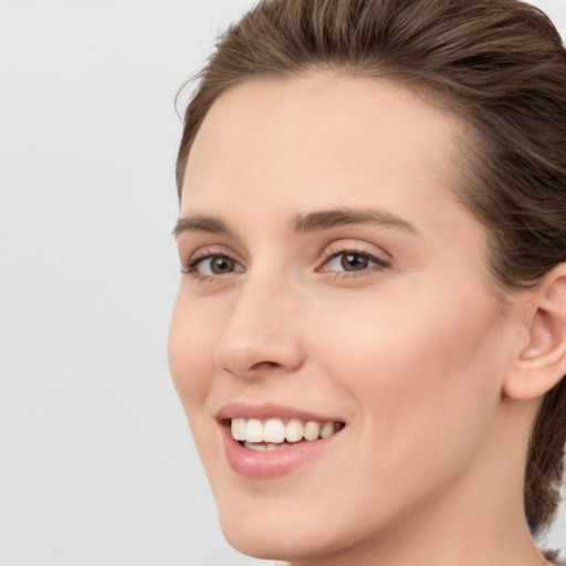 Joyful white young-adult female with medium  brown hair and grey eyes