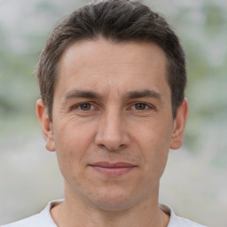 Joyful white adult male with short  brown hair and brown eyes