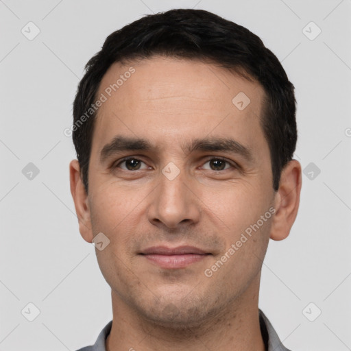 Joyful white young-adult male with short  black hair and brown eyes