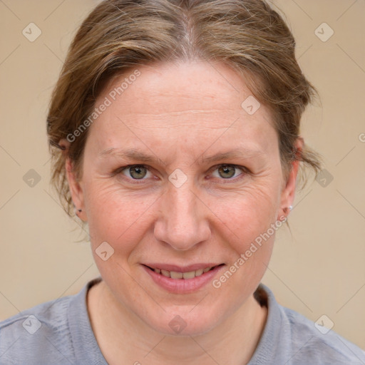 Joyful white adult female with medium  brown hair and blue eyes