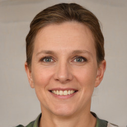 Joyful white adult female with short  brown hair and grey eyes