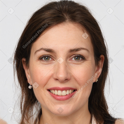 Joyful white adult female with medium  brown hair and grey eyes