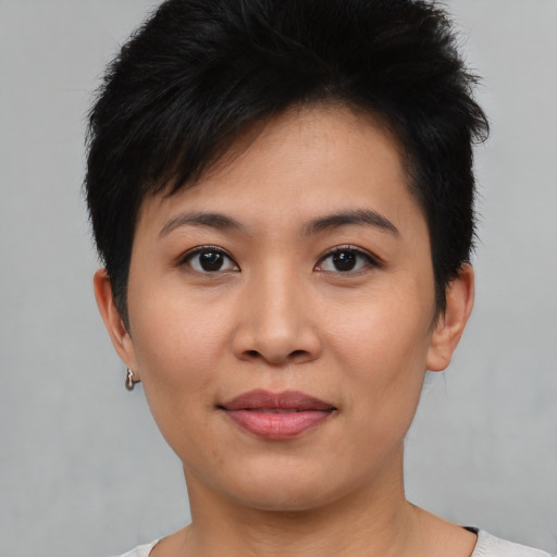 Joyful asian young-adult female with short  brown hair and brown eyes