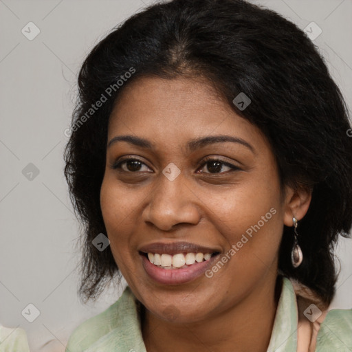 Joyful black young-adult female with long  brown hair and brown eyes