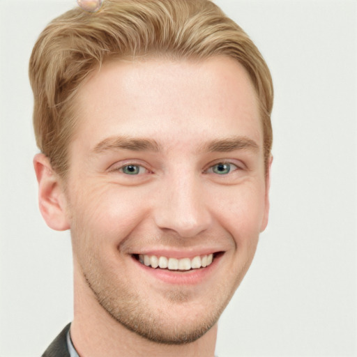 Joyful white young-adult male with short  brown hair and grey eyes