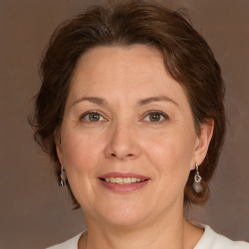 Joyful white adult female with medium  brown hair and green eyes